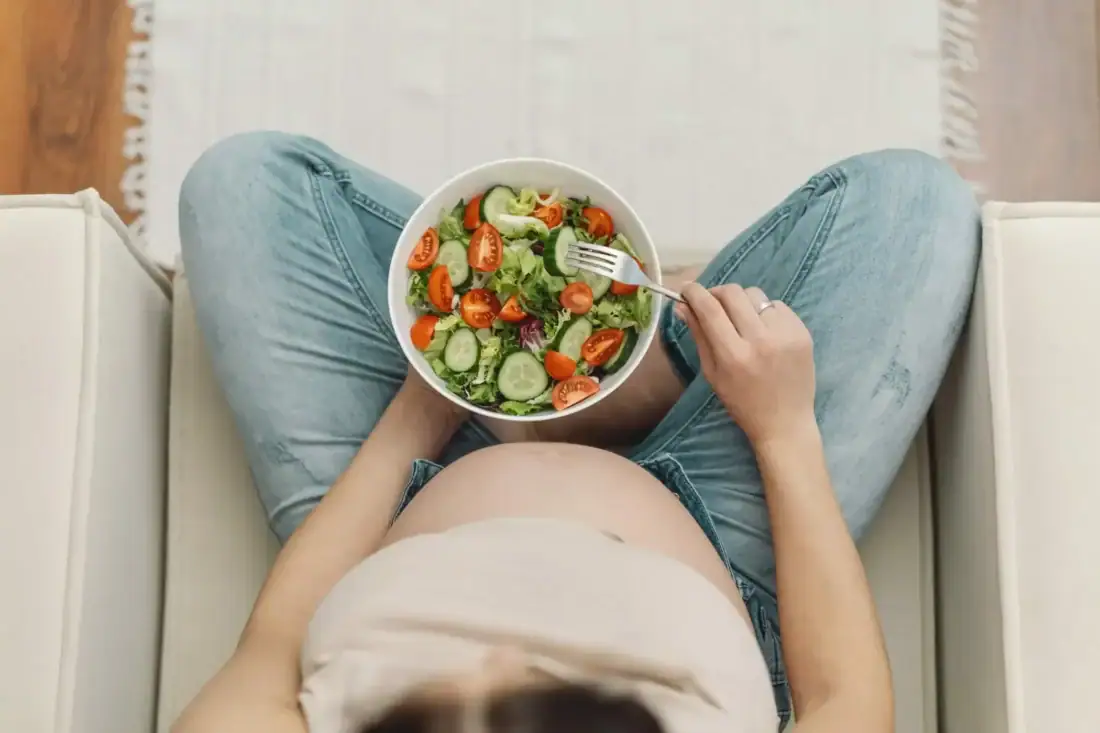 Healthy salad with vegetables and tomatoes, woman eats nutritious and balanced.