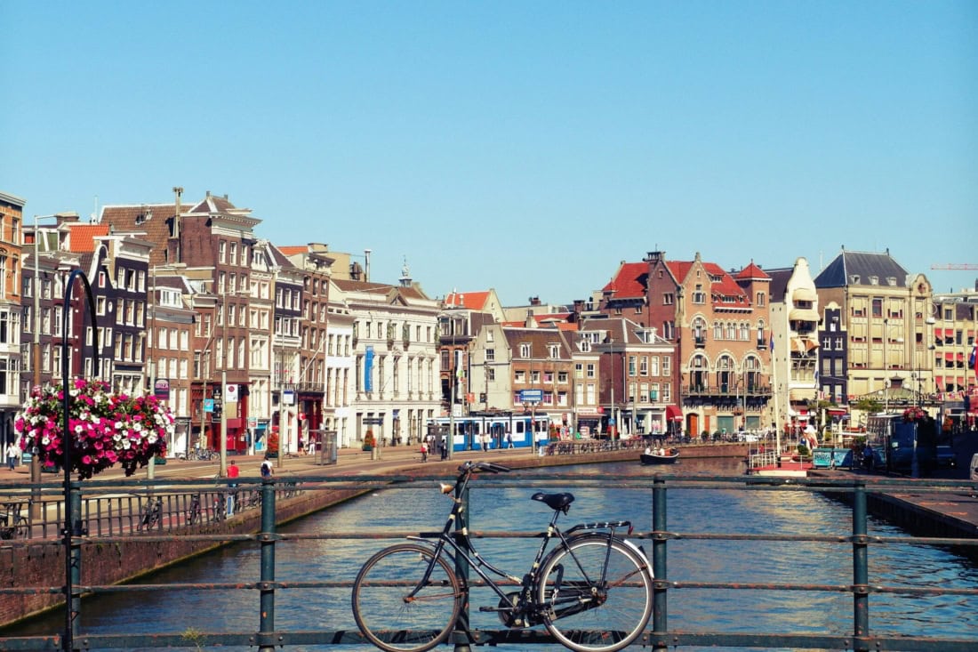 Cyclist by the canals in a historic Dutch city, tourist attraction, Netherlands.
